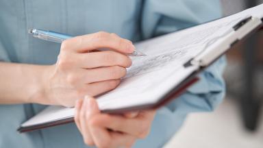 A nurse making notes.