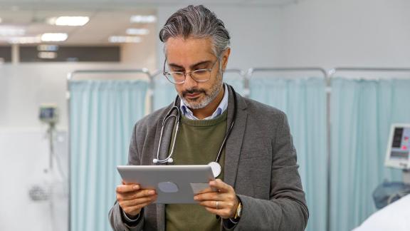 A doctor using an iPad.