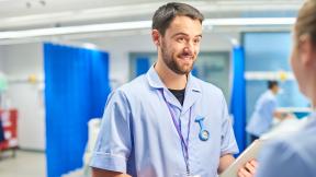 Student nurses talking on a ward.