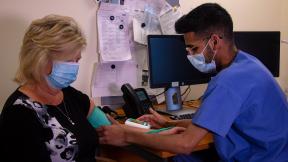 Nurse taking patient's blood pressure