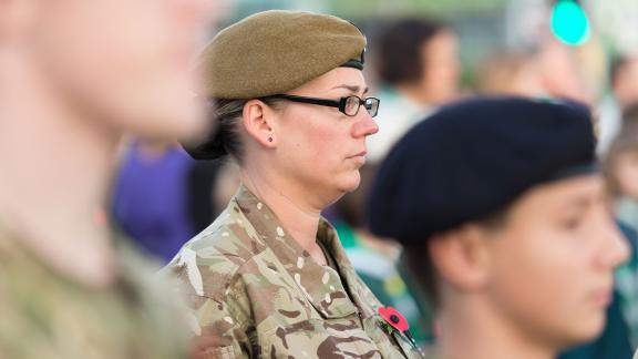 An army service member standing at a parade.