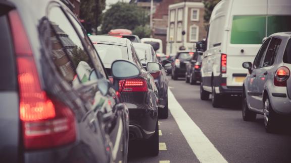 A row of cars on a busy road.