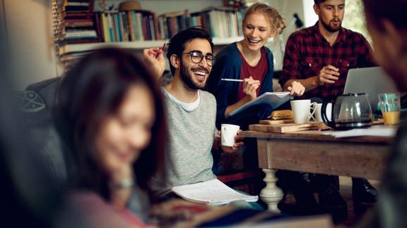 A group of students, studying and laughing.