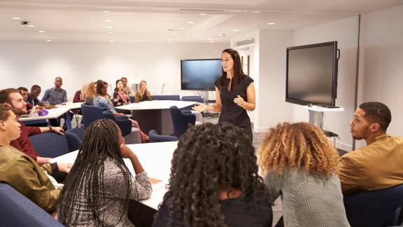 A seminar leader presenting to delegates.