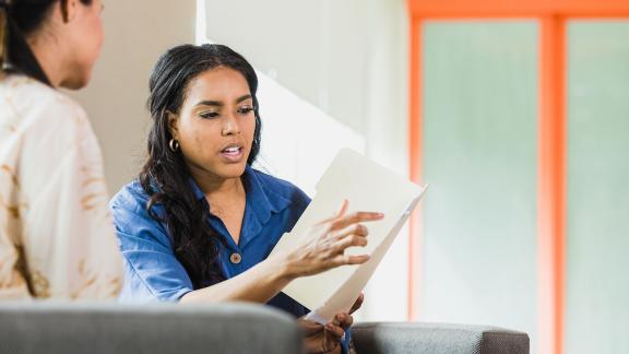 Two colleagues discussing a file.