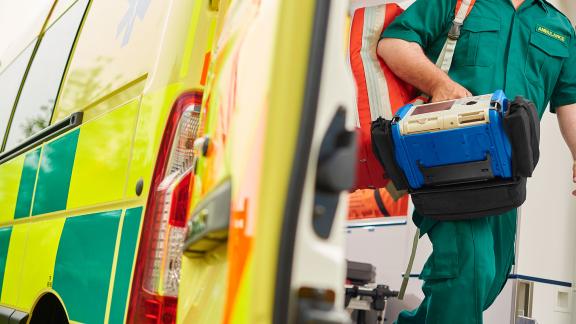 A paramedic leaving an ambulance.