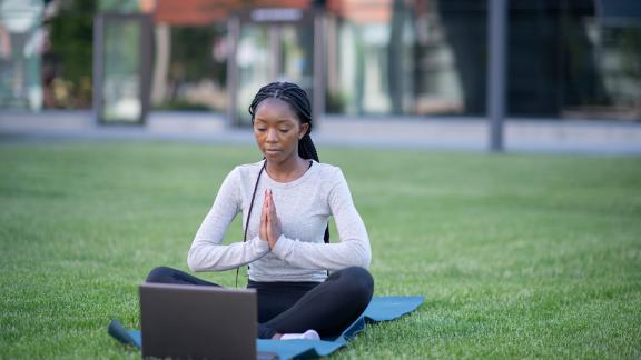 A woman doing yoga in the park.