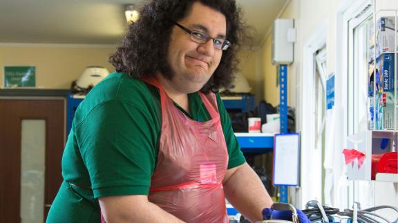 An apprentice tester cleaning equipment.