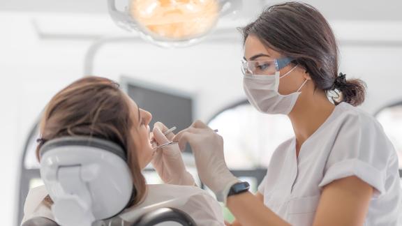 A dentist and patient mid-appointment.