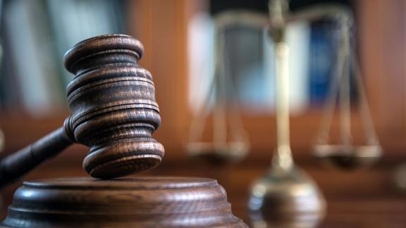 A gavel resting on its sound block.