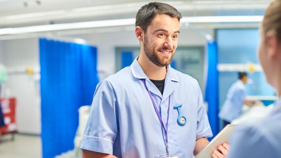 Student nurses talking on a ward.